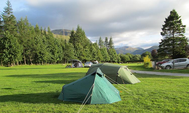 Mark and Ren's tents at lochy holiday park. Trees and Ben Nevis in the background