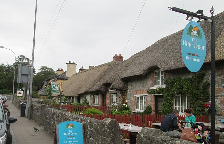 a row of low thatched houses being used as a restaurant in adare