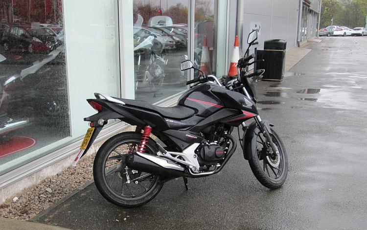 The all new Honda CB 125 F side on view outside a motorcycle shop