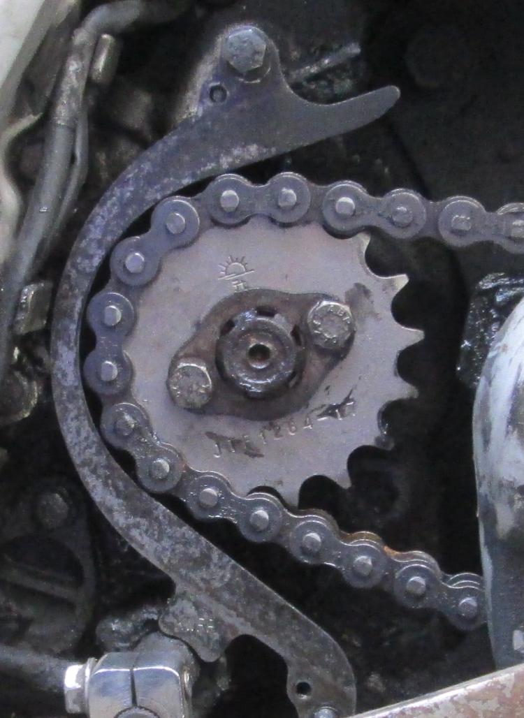 The sprocket in site and the protective metal guard is very close to the sprocket