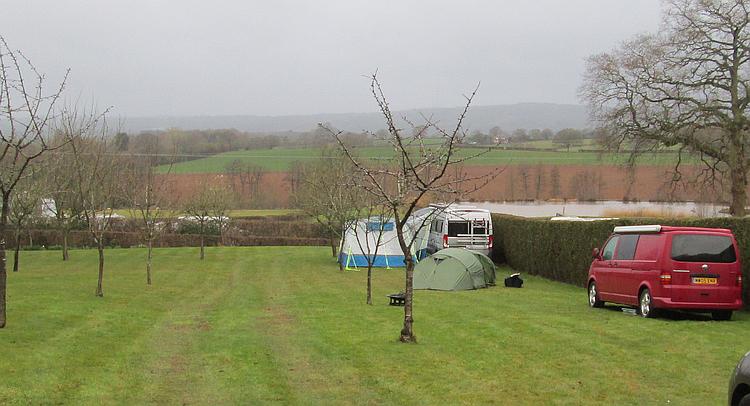 The tent looks small against the windswept field of the campsite