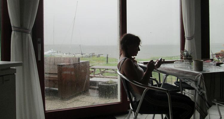 Sharon sits relaxing in the common room at Zandkreek
