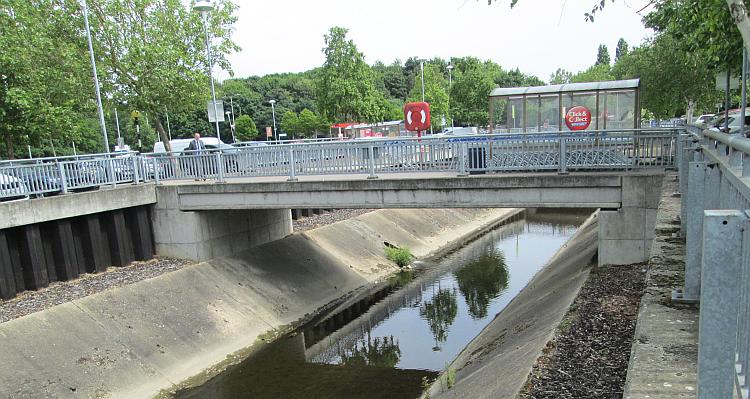 A concrete channel runs through the Tesco car park, looking rather industrial and dull