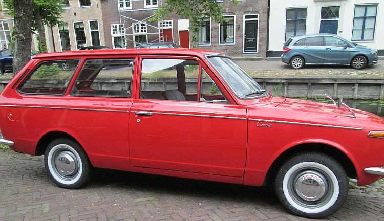 A mint condition classic toyota corolla by a canal in Edam