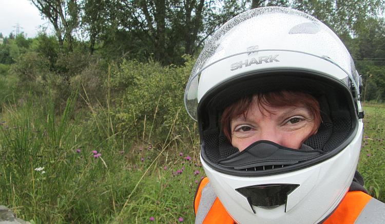 Sharon looks wryly at the camera with her helmet still on