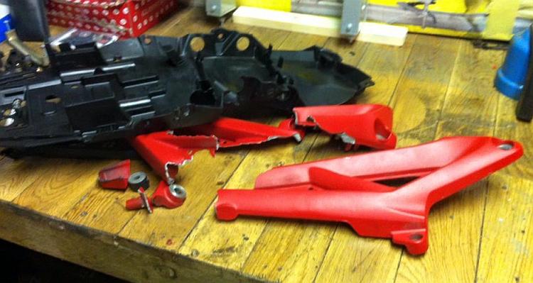 The broken shards of aluminium subframe and the bent plastic undertray