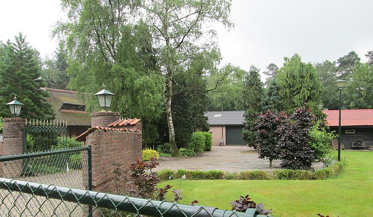 The neatly trimmed lawns, crisp brickwork and fresh paving of the house near the track
