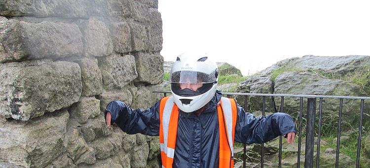 Sharon stands in all her bike gear soaking wet at home in England
