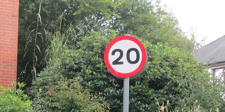A 20mph speed limit sign. 20 in a red circle on a post