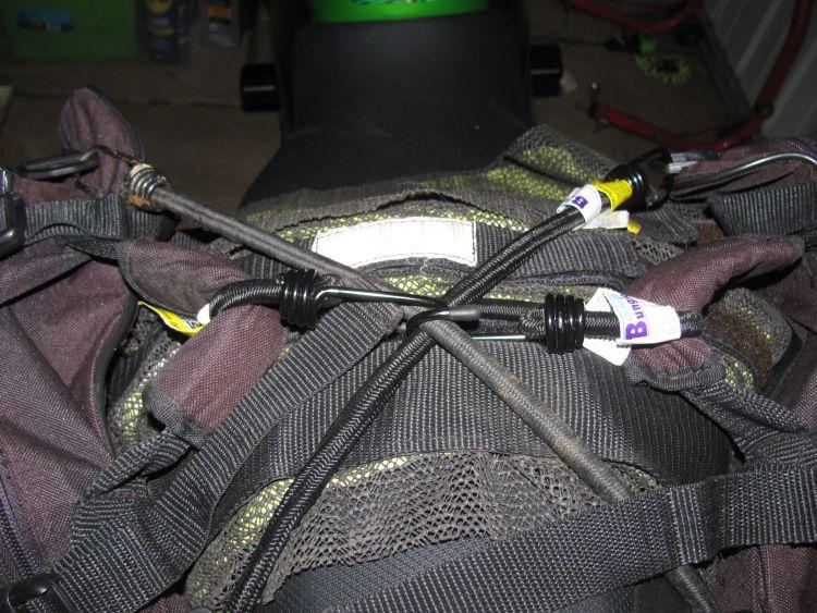 The tangled web of bungees and straps holding the saddle bags high.