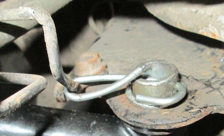 The original method of keeping the centre stand still. Wire wrapped around a part