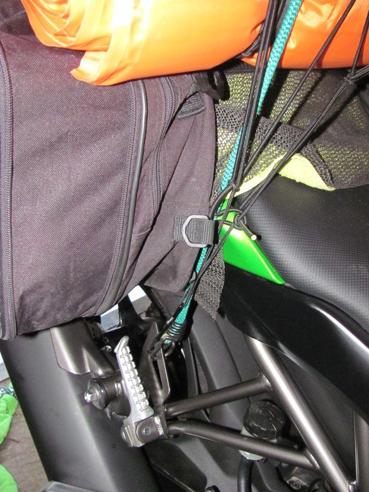The bungees and cargo net attach to the rear footrest plates