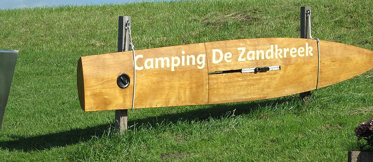 A wooden windsurfing board with 