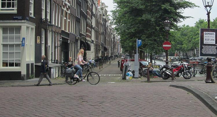 A female Dutch cyclist riding through Amsterdam