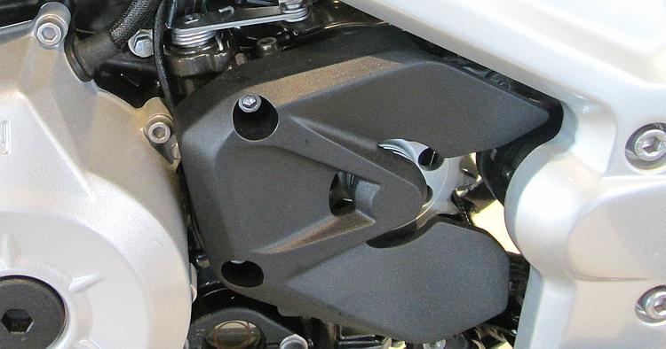 The front sprocket cover is partially cut away so the sprocket is visible