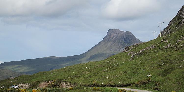 Stac Pollaidh, a mountain in the Highlands, sloping towards the top with an almost vertical outcrop at the top
