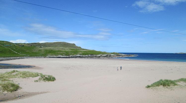 A broad beach with hills to either side at Clashnessie in Scotland