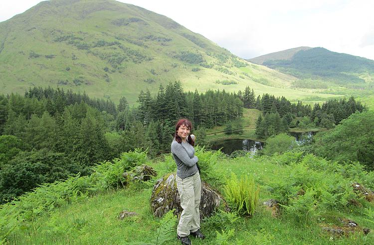 Sharon pointing to a Highland scene