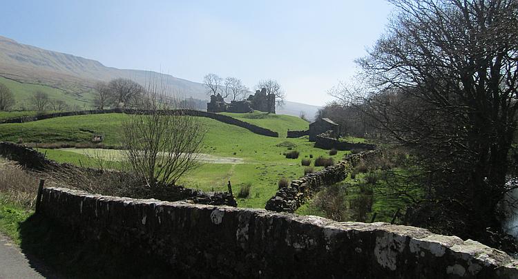 Pendragon Castle, ruins set against the green hills in the Dales