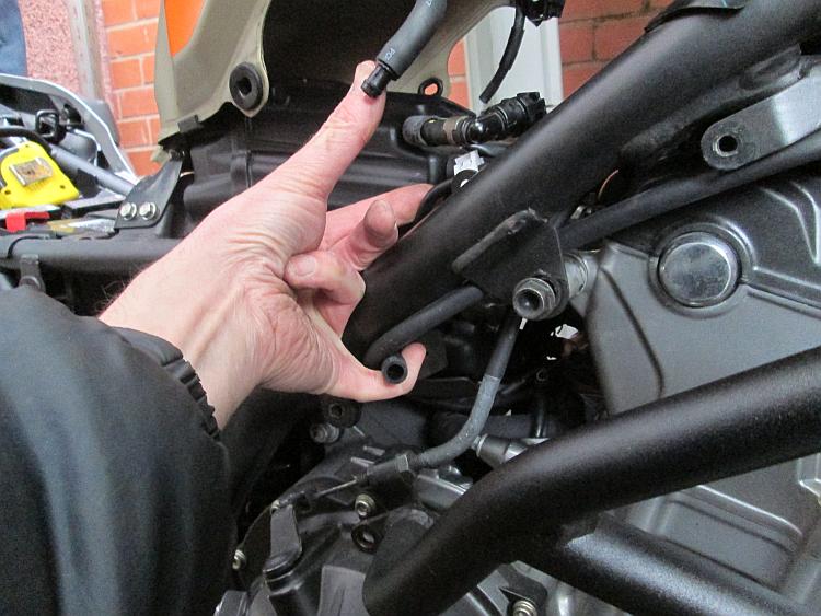 The larger pipe from the tank on the right side of the motorcycle