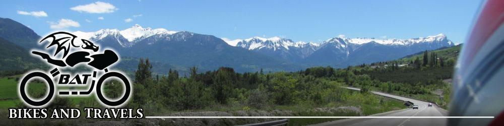 Looking across to the snow capped alpine mountains seen from the back seat of a motorcycle