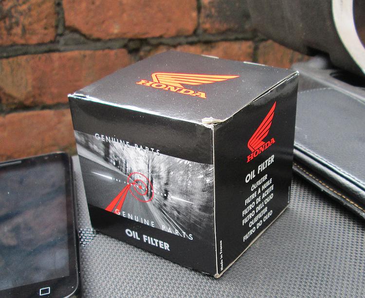 A small black box with Honda logos on it, within is the genuine Honda oil filter