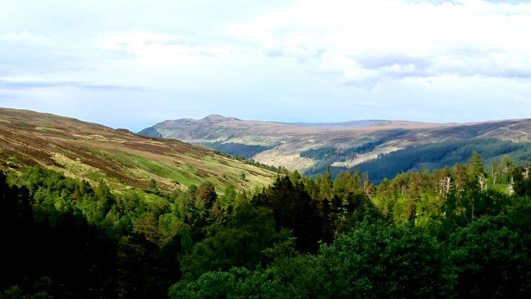 Angular hills and mountains intertwine into the distance across the Highland vista