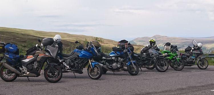 The same line of motorcycles from a different view into the distance valley