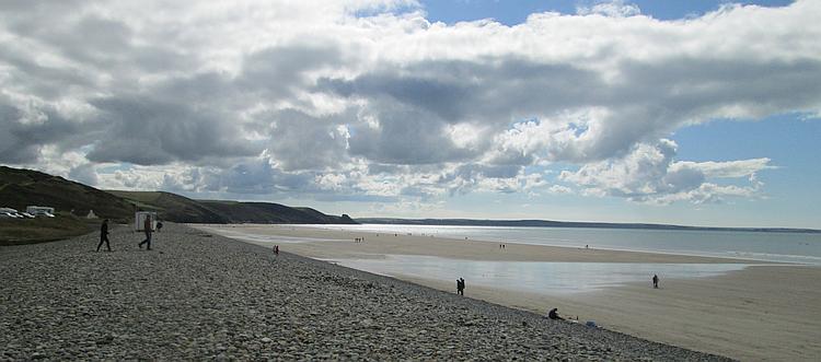 Vast broad sandy beach, a stone coastal defence and hills at Newgale Beach