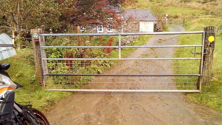A gate beyond which is only rough terrain, the end of this road