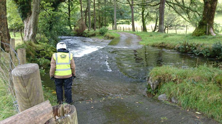 Ren stands considering the fast flowing ford in front of him deep in the countryside