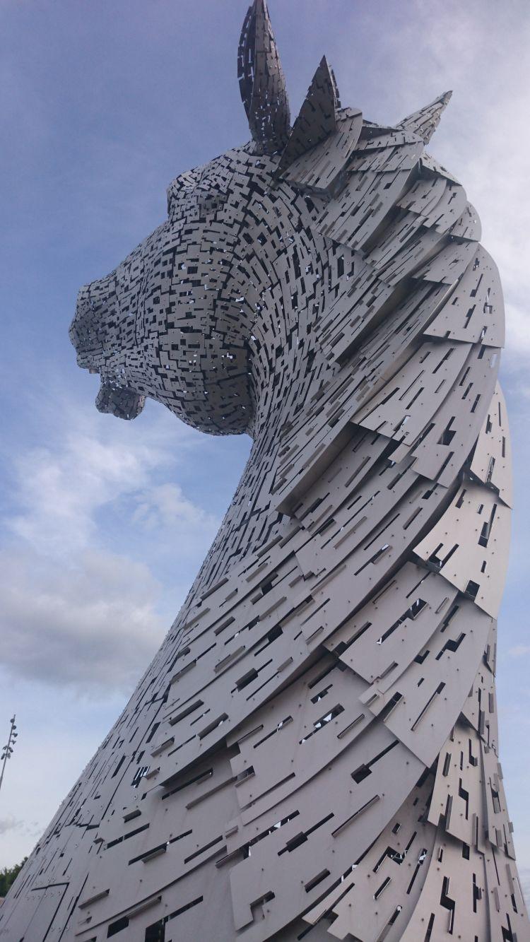 The back of one of the horse heads set against a blue sky