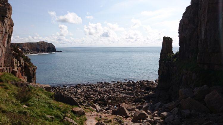Looking out from the chapel we see a rocky shoreline, cliffs and towering rocks