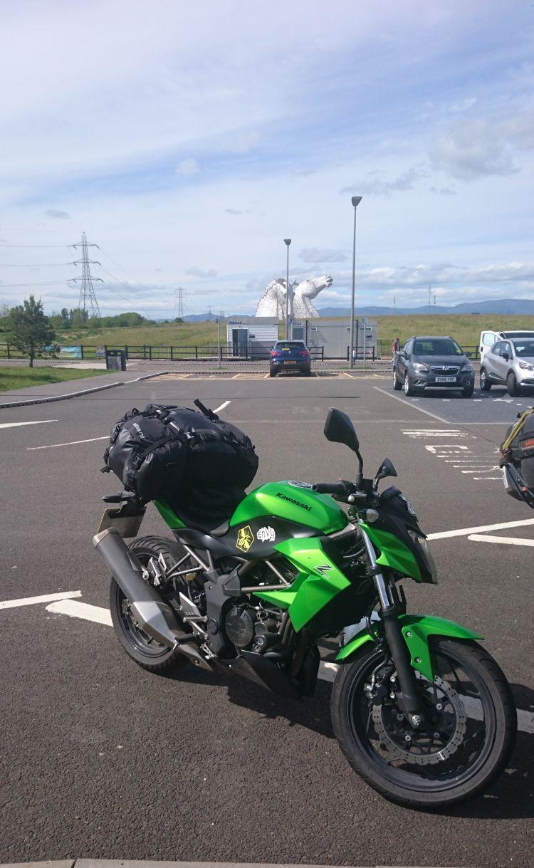 Sharon's motorcycles is in the foreground with the impressive steel horse's heads in the distance