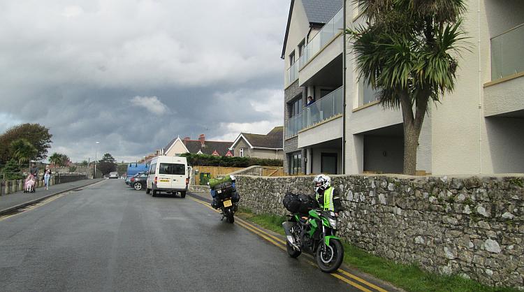 An apartment block and regular houses, vans and cars and streets in Tenby