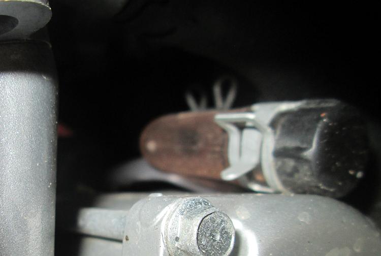 A small clear plastic tube on top of the starter motor that catches oil or condensation from the air box