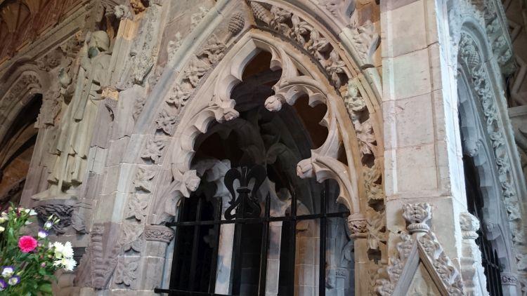 An arch with detailed and intricate carving upon it and in its overall shape