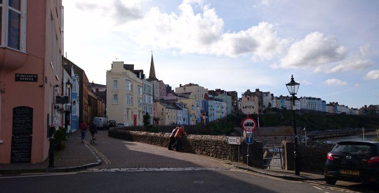 Houses and hotels line the harbour walls painted in pastel colours in the pleasant town
