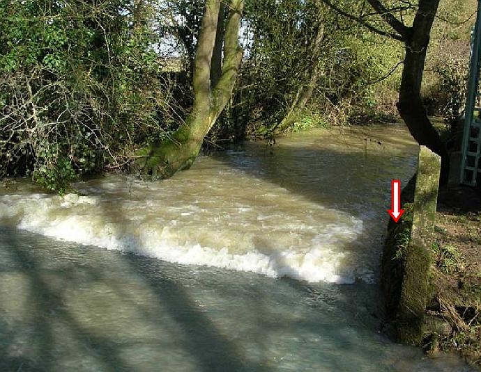 A ford with an arrow on it showing where the river had swelled to