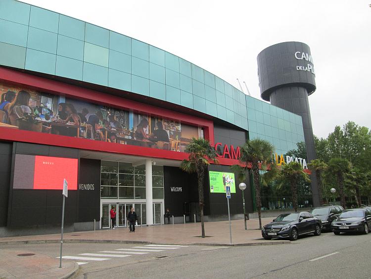 A large modern building houses shops and supermarkets