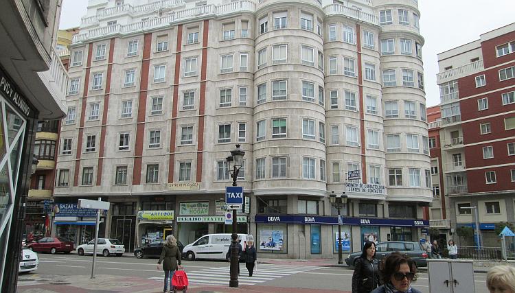 A large building with a bank on the ground floor is typical of the town centre