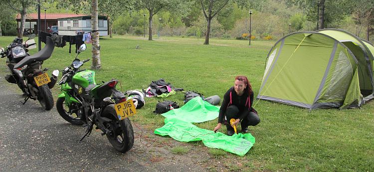 Sharon is inflating airbeds and there's washing on the line at a campsite in spain