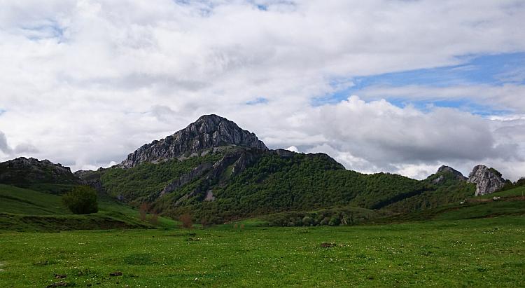 Down the side of the steep mountain are ridges of rock that could look like the spine of a huge creature