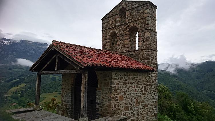 A small terracotta roofed building with a tall frontage where bells would have hung