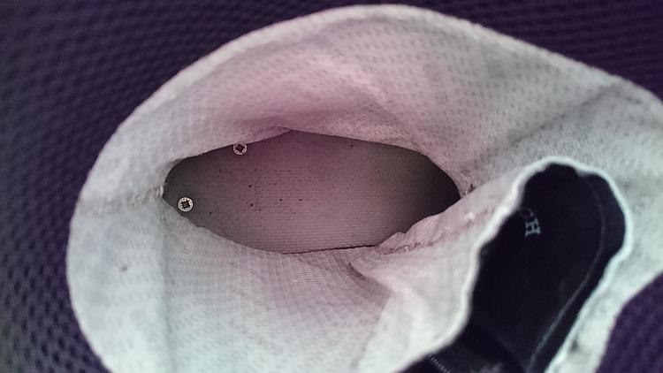 Looking down into Ren's left moto boot we can see 2 crosshead screw tops