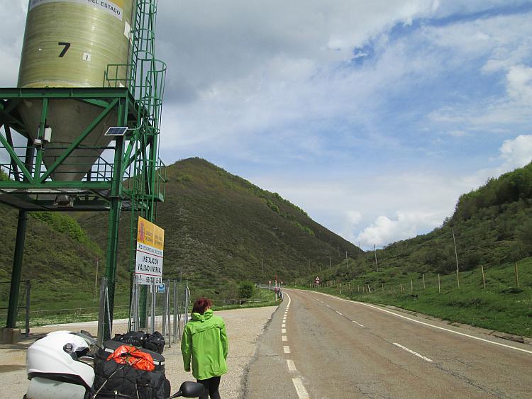Looking along the road we see steep angular hills covered in trees