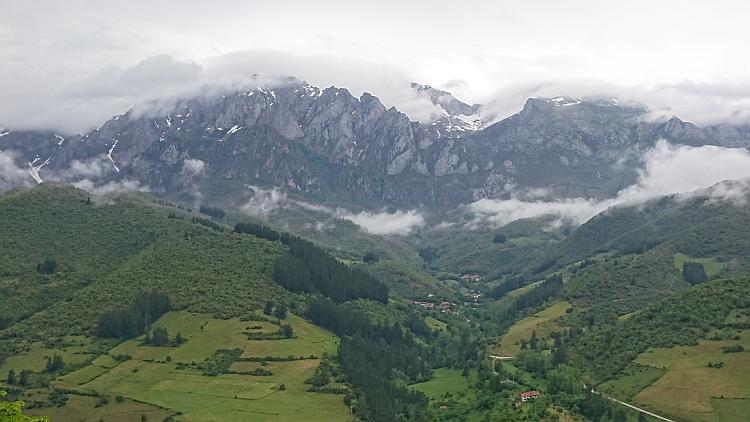 Tough rocky mountain tops with a sprinkling of snow amidt moving mists at Picos