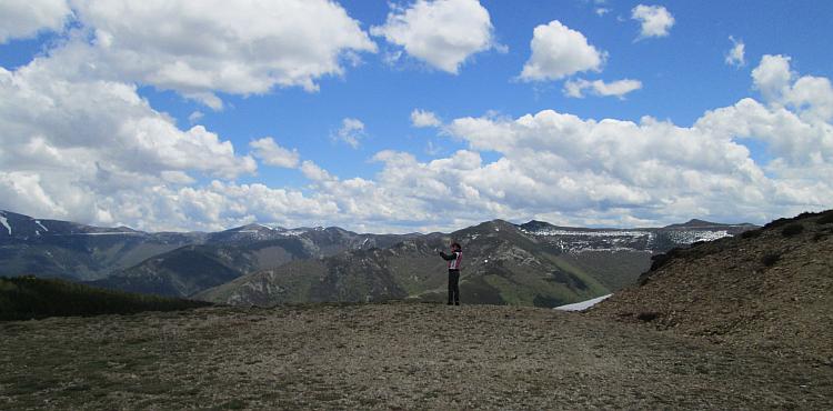 More mountains stretch away from the camera, sharon is in shot but she looks tiny against the huge scene