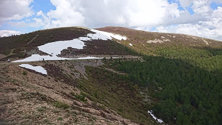 A swathe of snow extends over the road at the peak of The Alto Cruz
