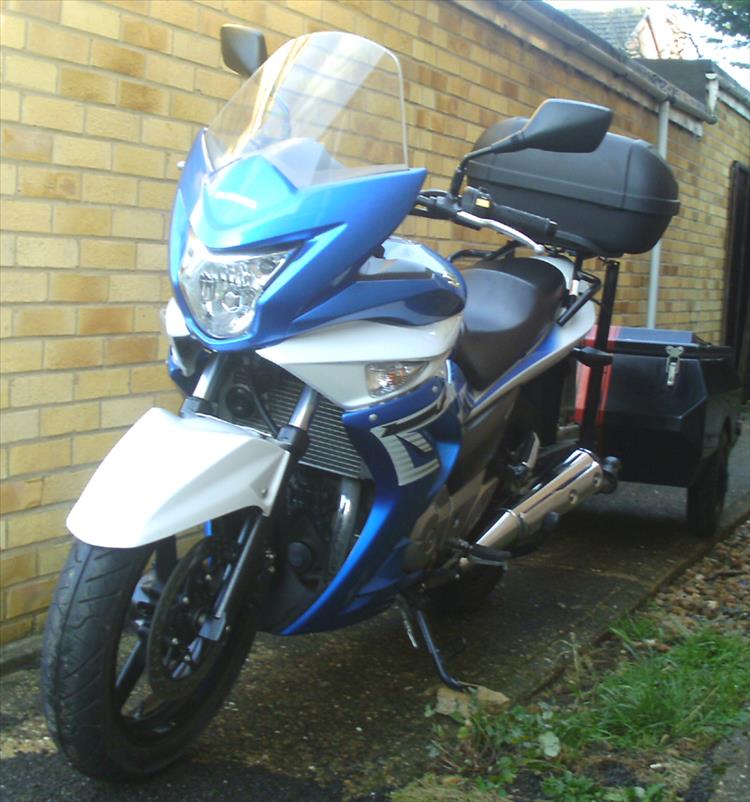 A suzuki 250 with a trailer on a tow bar